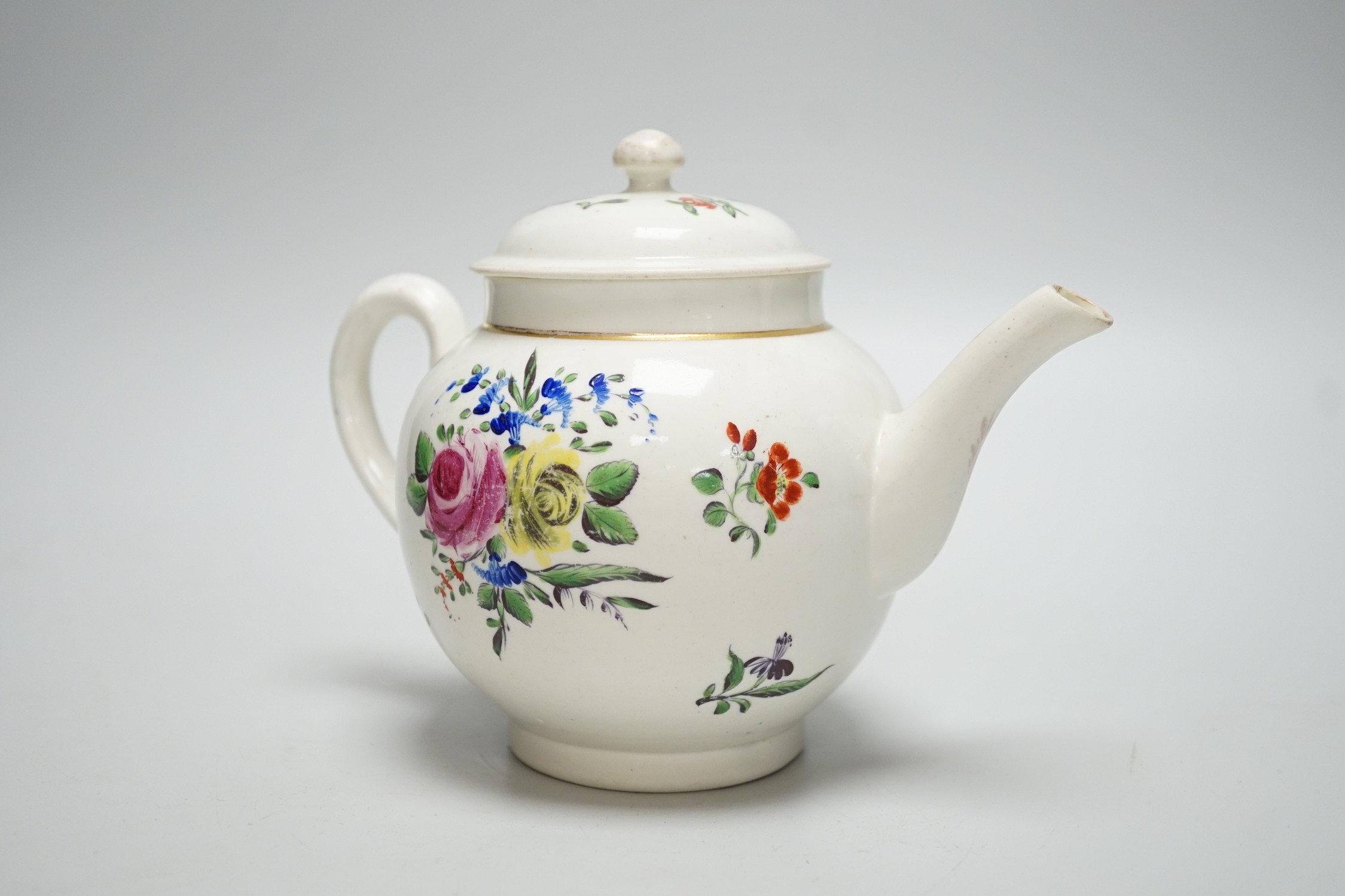 An 18th century Caughley teapot and cover with back to back roses, 15cms high